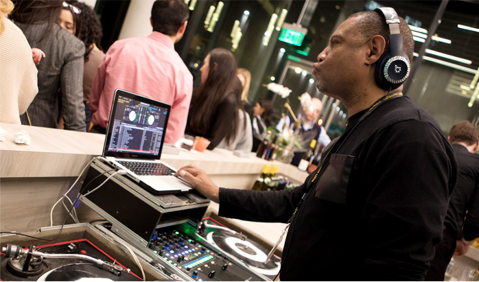 DJ plays music at the West Manhattan office grand opening.